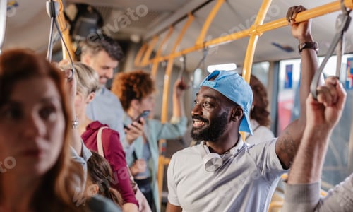 Preview: Smiling man commuting by public bus with diverse people