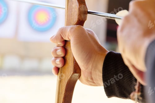 Preview: Archer holds his bow aiming at a target