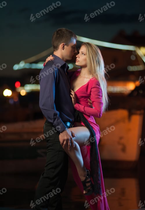 Preview: Young guy with a girl hug and dance tango at night on the city street