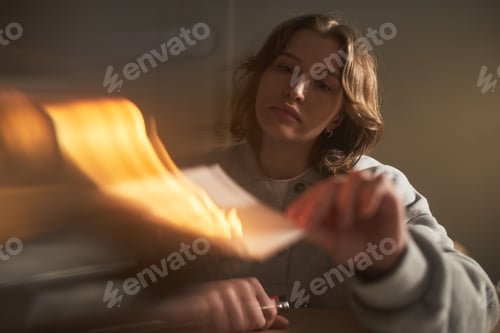 Preview: Young Adult Caucasian Woman Burning Paper While Expressing Intense Emotion