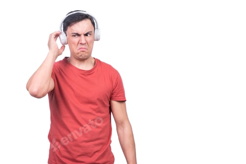 Preview: Discontent man in headphones against blank background