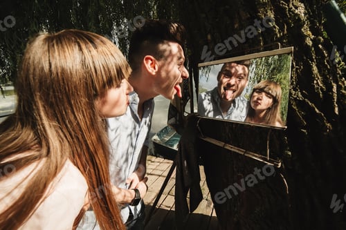 Preview: crazy young couple emotionally having fun, kissing and hugging outdoors. Love and tenderness,romance