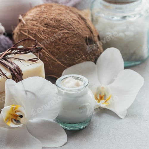 Preview: Organic cosmetics with coconut oil and handmade soap with white orchid flowers on grey background