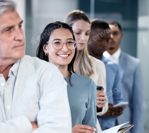 Preview: Portrait of a young businesswoman waiting in line in an office