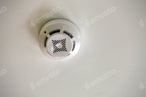 Preview: Smoke detector of fire alarm device on copy space background of white ceiling