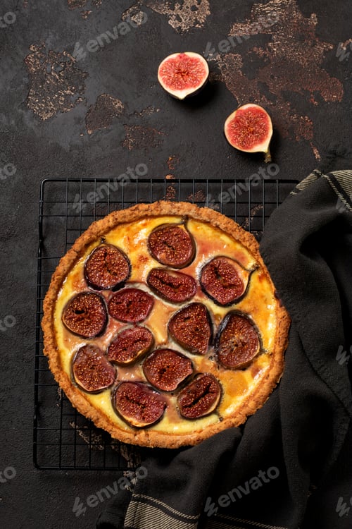 Preview: Homemade quiche tart with figs, cream cheese and honey on dark brown background. Vintage style. Top