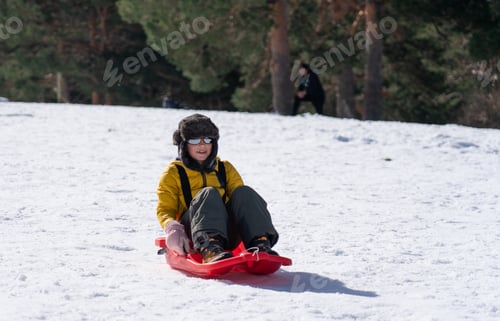 Preview: Happy boy sledding through the snow
