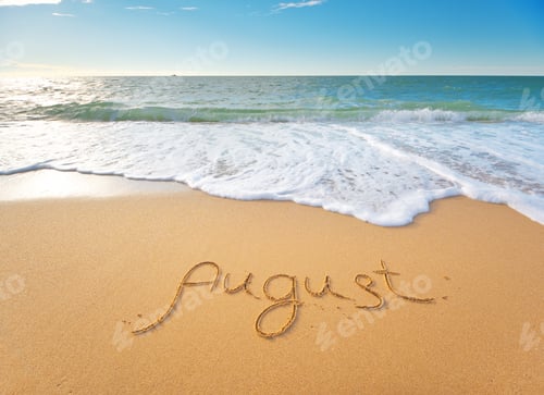 Vista previa: August word written on sea sand shore beach at day.