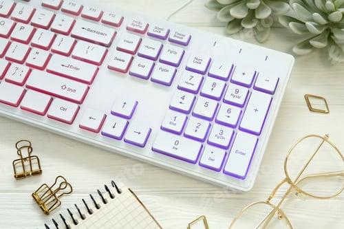 Preview: Modern RGB keyboard and eyeglasses on white wooden table