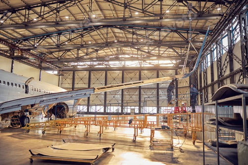 Preview: Wing and fuselage of the airplane in the aviation hangar