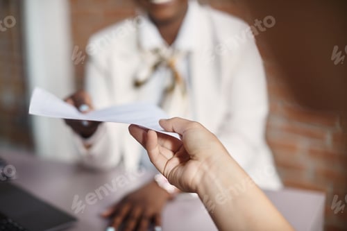 Preview: Close up of businesswoman taking CV from job candidate during meeting in the office.