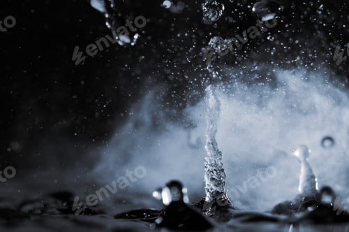 Preview: Boiling water splash with steam on black background closeup