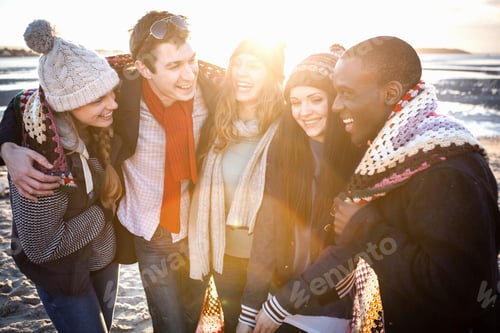 Preview: Friends sharing laughter on a sunny winter beach day