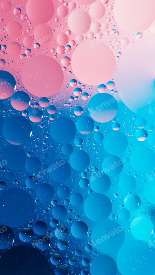 Preview: oil with bubbles on vibrant blue and pink background. Abstract background.