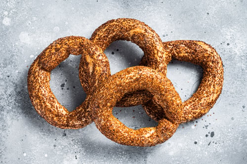 Preview: Turkish Bagel Simit with sesame traditional pastry. Gray background. Top view