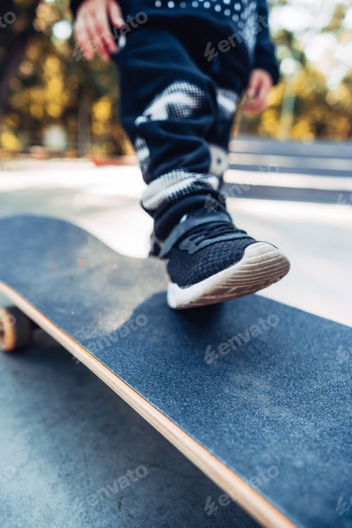 Preview: Boy legs on the skateboard close up image