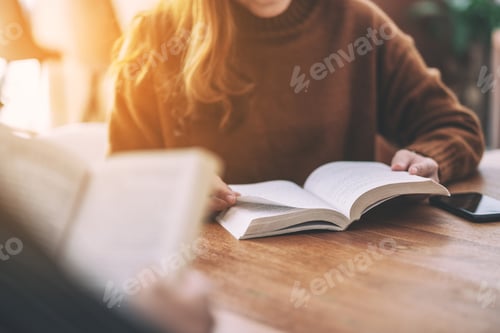 Preview: Group of people sitting and enjoyed reading books together on wooden table
