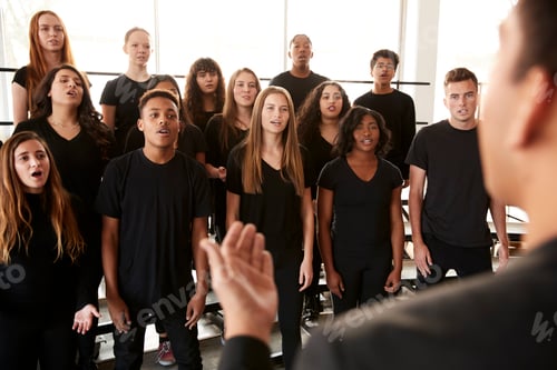 Preview: Male And Female Students Singing In Choir With Teacher At Performing Arts School