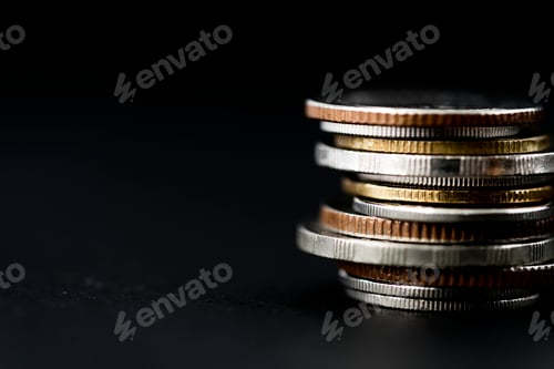 Preview: Closeup of coins stack isolated on black background