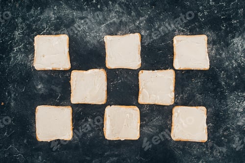 Preview: top view of tasty healthy toasts with butter on black