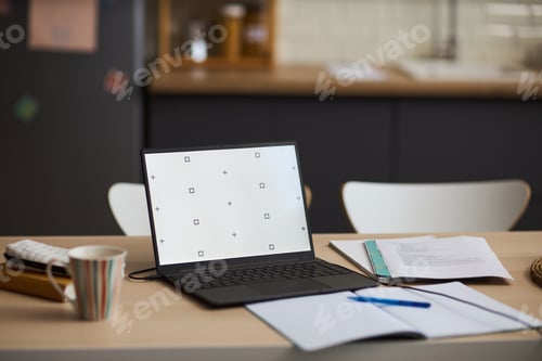 Preview: Open Laptop on Table Displaying Blank Screen with Documents and Coffee Cup