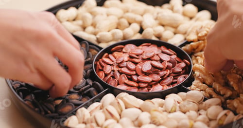 Preview: Hand taking snack from chinese snack tray box