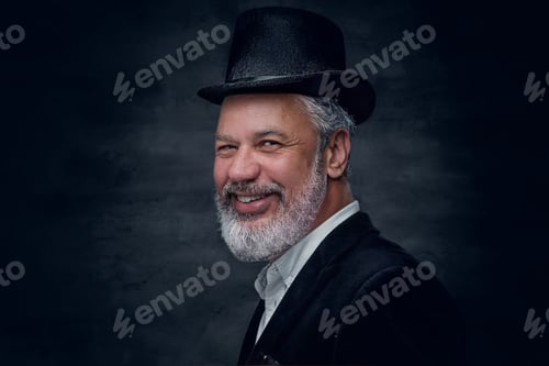 Preview: Glad old man with hat against dark background