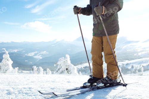 Preview: Man skiing in mountains. Skiing in snowy mountains, Winter is coming, snowfall. Active lifestyle.
