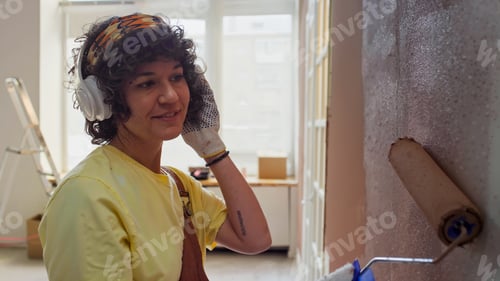 Preview: Hispanic Woman Completing Interior House Painting Project