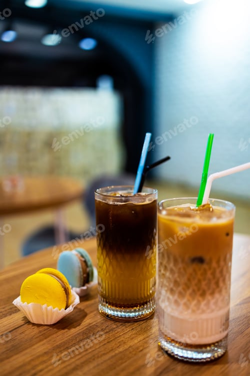 Preview: macaroons and iced black coffee with orange juice in cafe. Small business cafe and restaurant owner