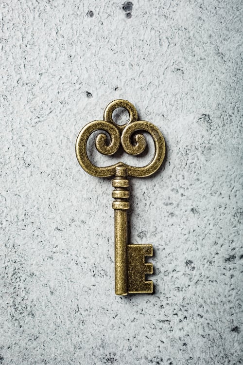 Preview: Old key on old gray concrete background.