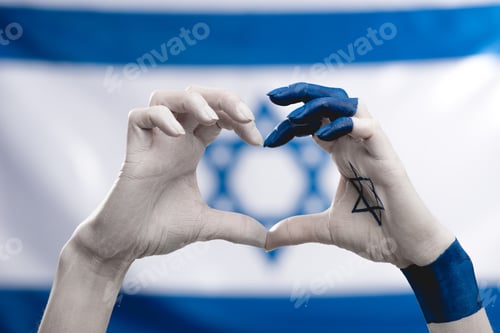Preview: cropped view of female hands with star of david showing heart near flag