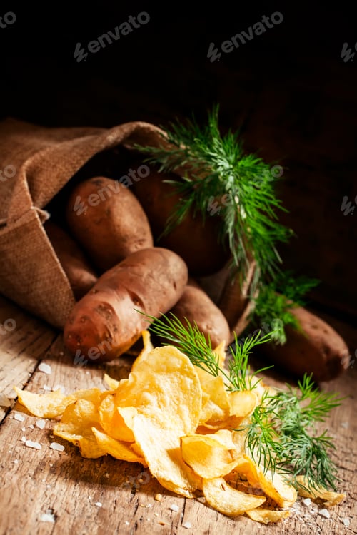 Preview: Salted potato chips with herbs on a wooden table vintage, country style, selective focus