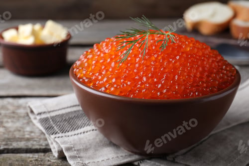 Preview: Bowl with delicious red caviar and dill on wooden table