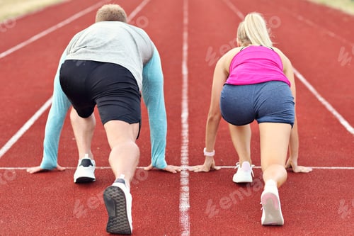 Preview: Man and woman racing on outdoor track
