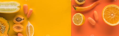 Preview: top view of yellow fruits and vegetables on orange background with copy space, panoramic shot
