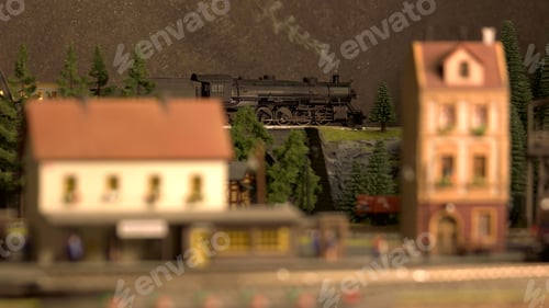 Preview: Toy locomotive moving on a bridge.