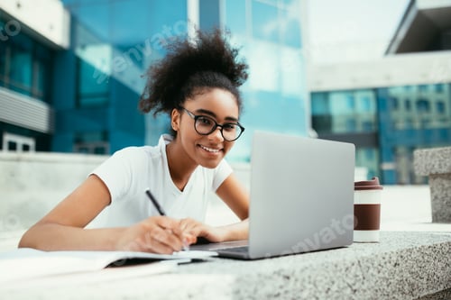 Preview: Cheerful African Student Girl Taking Notes At Laptop Outdoor