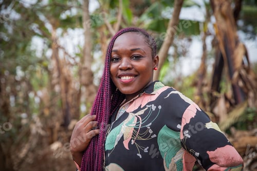 Preview: Portrait of an attractive young African woman smiling with braids.