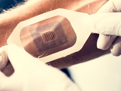Preview: Hands with gloves press a code scan on human arm
