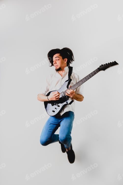 Preview: Guitarist posing with his electric guitar, white background.