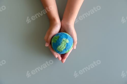 Preview: Hands holding earth paper and water paint. Concept of sustainability environment protection