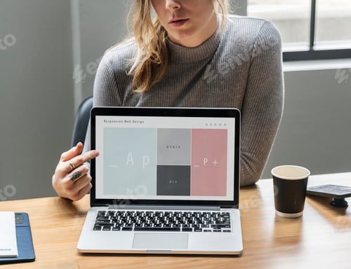 Preview: Blond woman pointing at a laptop screen