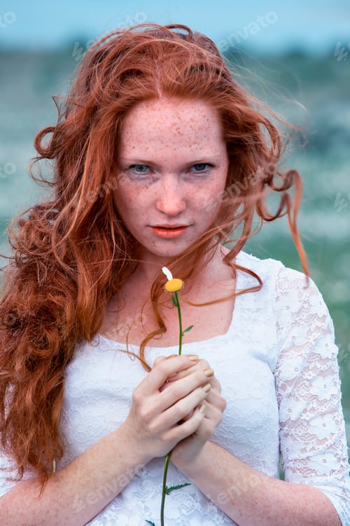 Preview: Beautiful woman enjoying daisy field in spring