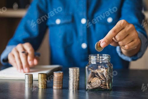 Preview: Businessman holding coins putting in glass. concept of saving money for finance accounting, for savi