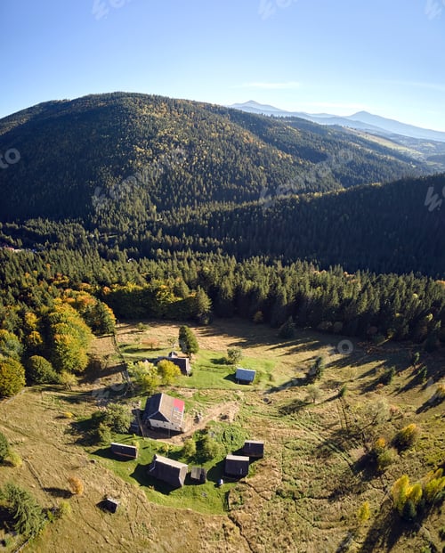 Preview: Aerial view of mountain hillside with small shepherd huts