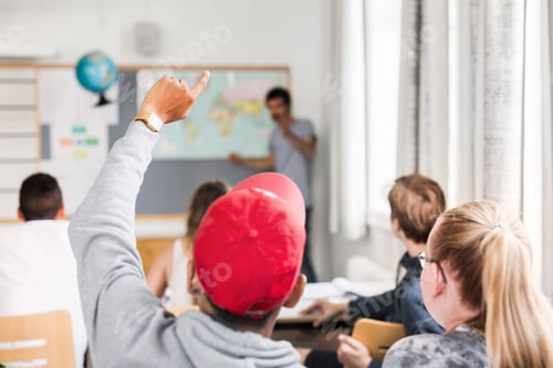 Preview: Student raising hand in a classroom setting
