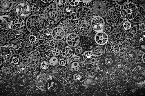 Preview: Steel cogwheels laying together tightly.