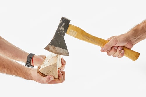 Preview: Partial view of men cutting log by axe isolated on white