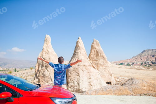 Preview: Happy man on summer vacation in famous place. Cave formations.